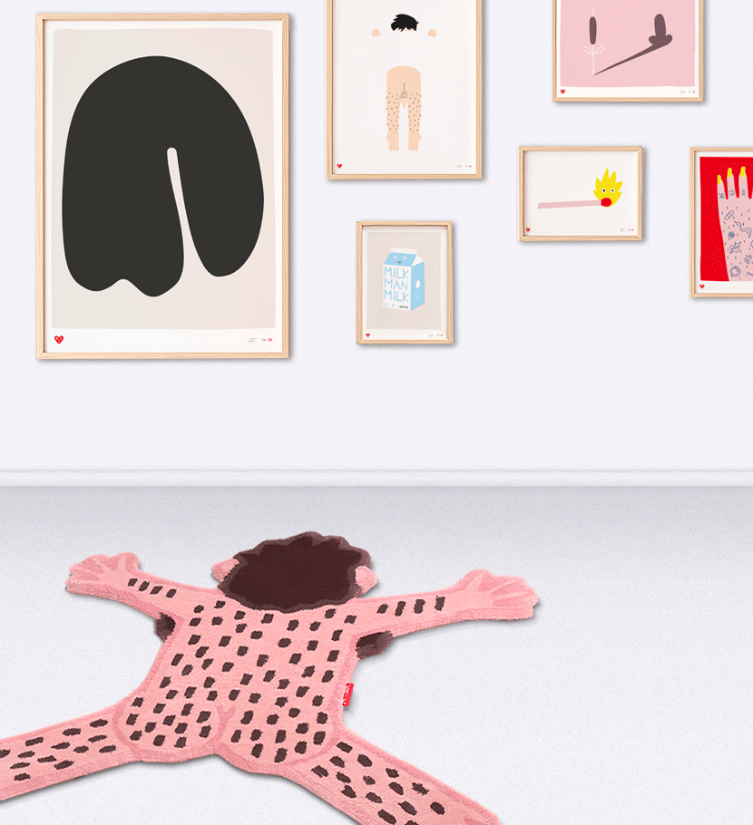 An interior image of the Bare Bear Rug (a hairy guy laying on the floor like a dead bear) and agains the wall you see an exhibition of the Art Screen Prints of Dicks Don't Lie. With the Elephant, Cheeky Chappy, Milkman Milk, The no going back, Nailed it and the Match that is lit on fire and has eyes in it.